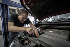 man performing basic car maintenance